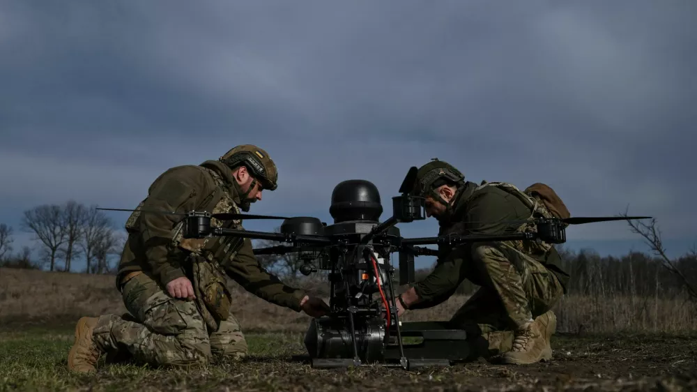 Service members of the 422nd Unmanned Systems Regiment attach a small air bomb to a heavy strike drone before a test flight at a training ground, amid Russia's attack on Ukraine, in Zaporizhzhia region, Ukraine March 23, 2026. REUTERS/Stringer