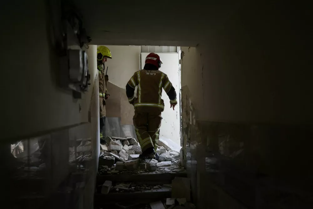 Firefighters work at the site where damage was caused following the launch of barrages of Iranian missiles towards Israel, amid the U.S.-Israeli conflict with Iran, in Tel Aviv, Israel March 26, 2026. REUTERS/Ronen Zvulun
