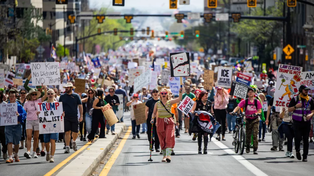 People take part in a "No Kings" protest where they marched from Washington Square Park to the Capitol in Salt Lake City on Saturday, March 28, 2026. (Tess Crowley/The Deseret News via AP)