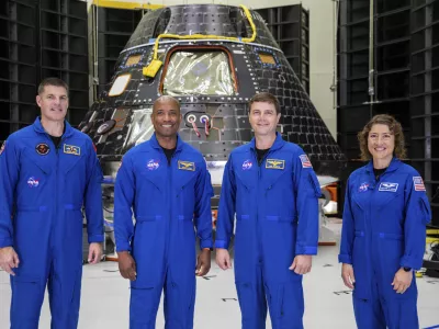 FILE - Artemis II crew members, from left, Jeremy Hansen, Victor Glover, Reid Wiseman and Christina Koch, stand together at NASA's Kennedy Space Center in Florida, in front of an Orion crew module on Tuesday, Aug. 8, 2023. On Tuesday, Jan. 9, 2024, NASA said astronauts will have to wait until 2025 before flying to the moon and another few years before landing on it. (Kim Shiflett/NASA via AP, File)