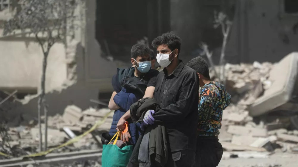 People walk in a residential neighbourhood damaged by a strike, amid the U.S.-Israeli conflict with Iran, in Tehran, Iran, March 30, 2026. Majid Asgaripour/WANA (West Asia News Agency) via REUTERS ATTENTION EDITORS - THIS PICTURE WAS PROVIDED BY A THIRD PARTY
