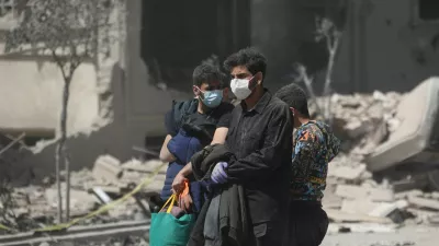 People walk in a residential neighbourhood damaged by a strike, amid the U.S.-Israeli conflict with Iran, in Tehran, Iran, March 30, 2026. Majid Asgaripour/WANA (West Asia News Agency) via REUTERS ATTENTION EDITORS - THIS PICTURE WAS PROVIDED BY A THIRD PARTY