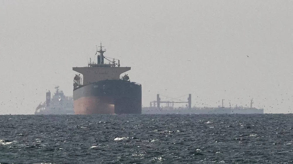 FILE PHOTO: Cargo ships in the Gulf, near the Strait of Hormuz, as seen from northern Ras al-Khaimah, near the border with Oman's Musandam governance, amid the U.S.-Israeli conflict with Iran, in United Arab Emirates, March 11, 2026. REUTERS/Stringer//File Photo