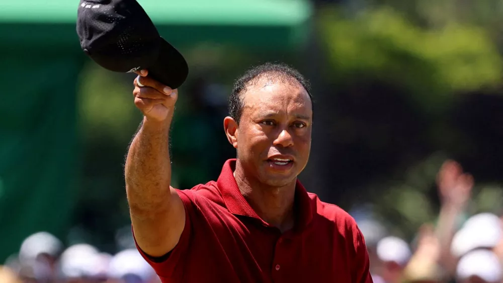 FILE PHOTO: Golf - The Masters - Augusta National Golf Club, Augusta, Georgia, U.S. - April 14, 2024 Tiger Woods of the U.S. acknowledges the crowd on the green on the 18th hole after completing his final round REUTERS/Mike Blake/File Photo