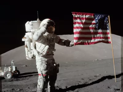 6261520 Astronaut Eugene A. Cernan, Apollo 17 commander, is photographed next to the deployed United States flag during lunar surface extravehicular activity (EVA) at the Taurus-Littrow landing site. The highest part of the flag appears to point toward our planet Earth in the distant background, 1972 (photo). No Use Germany. No Use Italy.