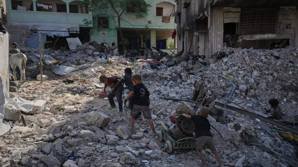 Palestinian children walk among destroyed buildings in Gaza City, Thursday, Oct. 16, 2025. (AP Photo/Jehad Alshrafi) / Foto: Jehad Alshrafi