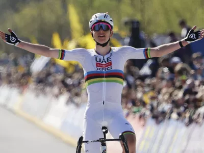 Slovenia's Tadej Pogacar, of the UAE Team Emirates XRG, crosses the finish line to win the Tour of Flanders in Oudenaarde, Belgium on Sunday, April 6, 2025. (AP Photo/Geert Vanden Wijngaert)