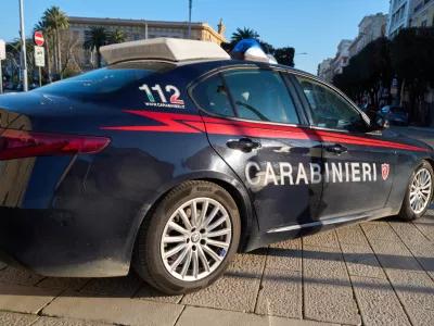 A Carabinieri patrol car is parked along a street in Bari, Italy, on March 24, 2026, with the emergency number 112 visible on the vehicle, indicating law enforcement presence in the city. (Photo by Matteo Della Torre/NurPhoto)NO USE FRANCE