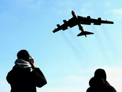 A plane spotter takes pictures as a U.S. Air Force Boeing B-52 Stratofortress takes off at RAF Fairford airbase, used by United States Air Force (USAF) personnel, amid the U.S.&ndash;Israeli conflict with Iran, in Fairford, Gloucestershire, Britain, March 15, 2026. REUTERS/Jack Taylo