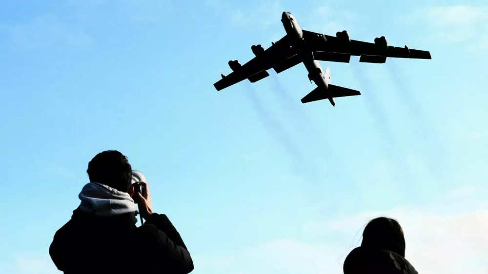 A plane spotter takes pictures as a U.S. Air Force Boeing B-52 Stratofortress takes off at RAF Fairford airbase, used by United States Air Force (USAF) personnel, amid the U.S.&ndash;Israeli conflict with Iran, in Fairford, Gloucestershire, Britain, March 15, 2026. REUTERS/Jack Taylo