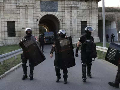 Serbian gendarmerie officers take positions on a street to separate anti-government protesters and supporters of Serbian President Aleksandar Vucic in Novi Sad, Serbia, Saturday, Sept. 13, 2025. (AP Photo/Marko Drobnjakovic)