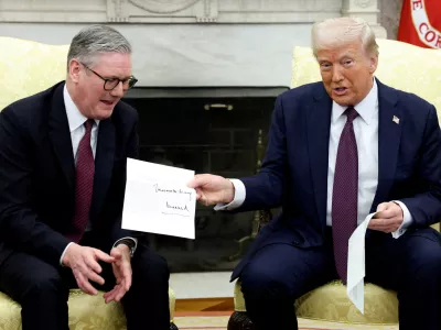 FILE PHOTO: U.S. President Donald Trump holds a letter from Britain's King Charles as he meets with British Prime Minister Keir Starmer in the Oval Office at the White House in Washington, D.C., U.S., February 27, 2025. REUTERS/Kevin Lamarque/File Photo
