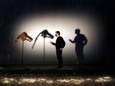 23 November 2021, United Kingdom, Edinburgh: A person views a whicker mask displayed at the exhibition Khvay Samnang: Calling for Rain. The exhibition by Cambodia-based artist Khvay Samnang also features two 11 metre long multicoloured curtains of rain. Photo: Andrew Milligan/PA Wire/dpa