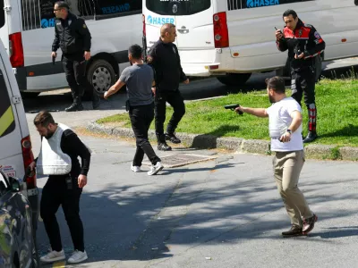 A plainclothes police officer holds a gun, after gunfire was heard near the building housing the Israeli consulate, according to a witness, in Istanbul, Turkey, April 7, 2026. REUTERS/Murad Sezer REFILE - ADDING INFORMATION "A PLAINCLOTHES POLICE OFFICER".   TPX IMAGES OF THE DAY