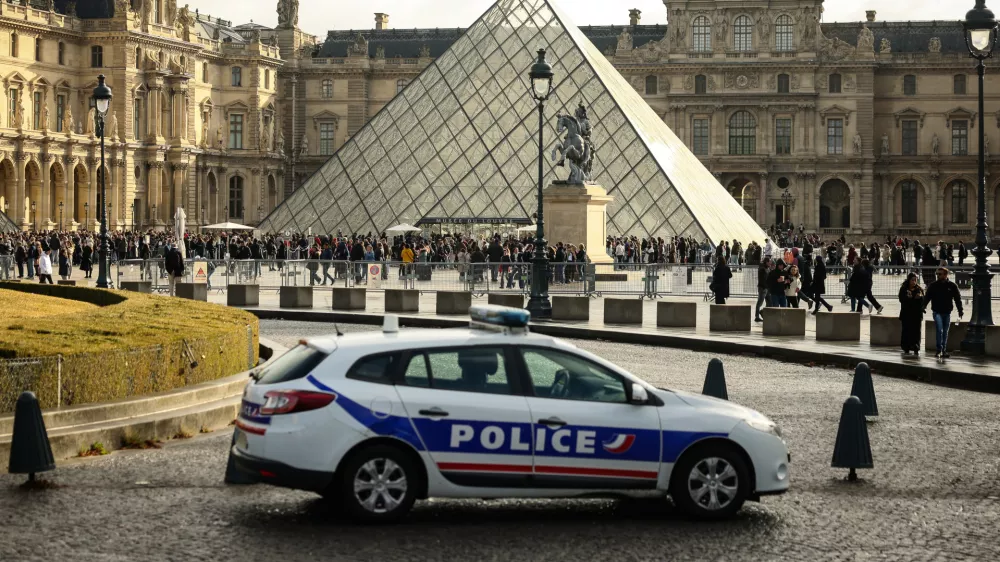 FILE - A police car parks in the courtyard of the Louvre museum, one week after the robbery, on Oct. 26, 2025, in Paris. (AP Photo/Thomas Padilla, File)