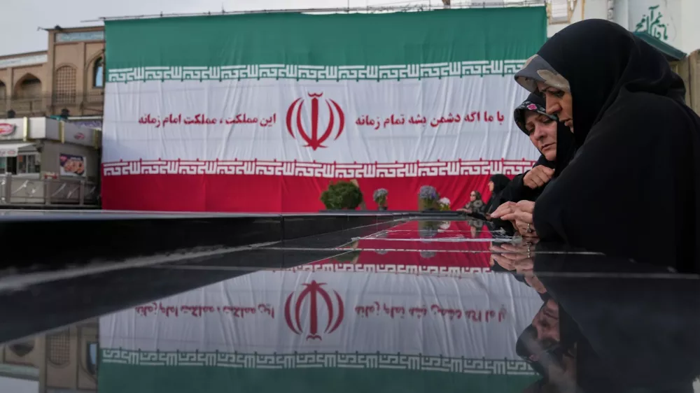Women pay their respects at a memorial to the unknown soldier and nuclear scientists killed during the 2025 Twelve-Day War, at the Emamzadeh Saleh Shrine in Tehran, Iran, Tuesday, April 7, 2026. (AP Photo/Francisco Seco)