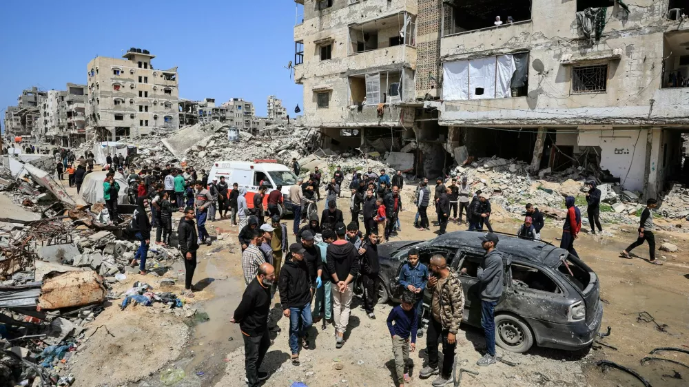 Palestinians inspect the damage after a person was hit by an Israeli strike while riding a bicycle, according to medics, in Gaza City, April 6, 2026. REUTERS/Dawoud Abu Alkas