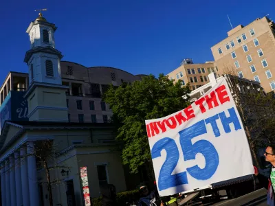 Demonstrators hold a banner during a protest against military action in Iran after U.S. President Donald Trump said that he had agreed to a two-week ceasefire with Iran, less than two hours before his deadline for Tehran to reopen the Strait of Hormuz or face widespread attacks on its civilian infrastructure, outside the White House in Washington, D.C., U.S., April 7, 2026. REUTERS/Nathan Howard