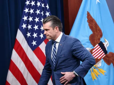 U.S. Secretary of Defense Pete Hegseth walks, as he attends a press briefing in the Pentagon Press briefing room, following the announcement of a two-week ceasefire in the Iran war, at the Pentagon in Washington, D.C., U.S., April 8, 2026. REUTERS/Kevin Lamarque