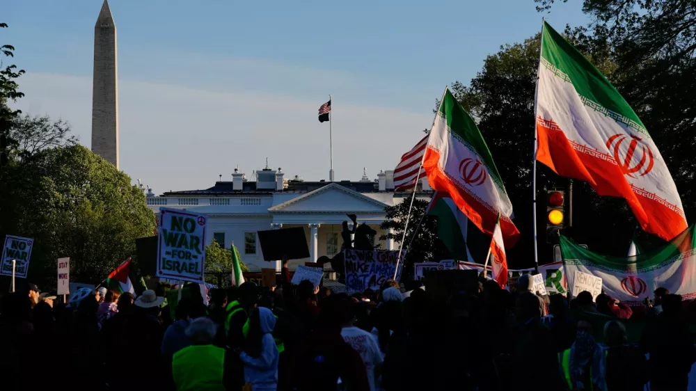 Demonstrators protest against military action in Iran after U.S. President Donald Trump said that he had agreed to a two-week ceasefire with Iran, less than two hours before his deadline for Tehran to reopen the Strait of Hormuz or face widespread attacks on its civilian infrastructure, outside the White House in Washington, D.C., U.S., April 7, 2026. REUTERS/Nathan Howard