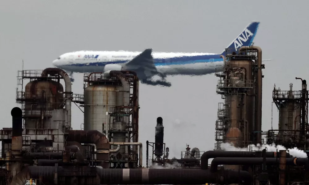 An All Nippon Airways airplane flies past an oil refinery as it approaches to land at Tokyo's Haneda airport, as seen from a park in the Keihin Industrial Zone in Kawasaki, south of Tokyo, Japan, March 17, 2026. REUTERS/Issei Kato   TPX IMAGES OF THE DAY