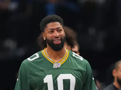 Dallas Mavericks forward Anthony Davis wears a NFL quarterback Jordan Love, of the Green Bay Packers, during the first half of an NBA basketball game against the Portland Trail Blazers Sunday, Nov. 16, 2025, in Dallas. (AP Photo/Julio Cortez)