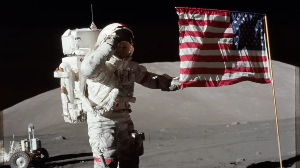 6261520 Astronaut Eugene A. Cernan, Apollo 17 commander, is photographed next to the deployed United States flag during lunar surface extravehicular activity (EVA) at the Taurus-Littrow landing site. The highest part of the flag appears to point toward our planet Earth in the distant background, 1972 (photo). No Use Germany. No Use Italy.