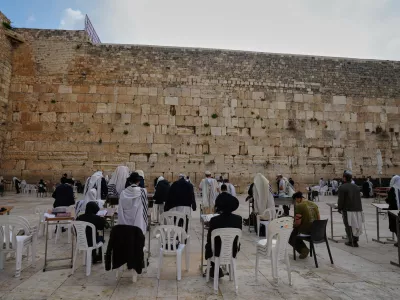 Ultra-Orthodox Jewish men pray at the Western Wall, the holiest site where Jews can pray, after restrictions were lifted following a ceasefire reached between Iran, Israel and the United States, in the Old City of Jerusalem, Thursday, April 9, 2026. (AP Photo/Mahmoud Illean)