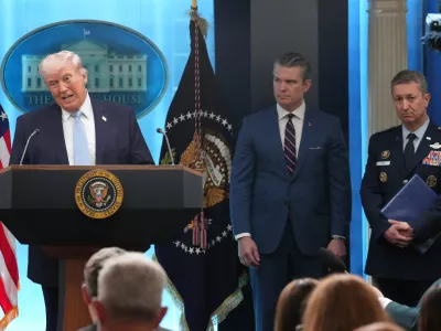 FILE - President Donald Trump speaks with reporters during a news conference in the James Brady Press Briefing Room at the White House, Monday, April 6, 2026, in Washington, as Defense Secretary Pete Hegseth and Chairman of the Joint Chiefs of Staff Gen. Dan Caine listen. (AP Photo/Mark Schiefelbein, File)