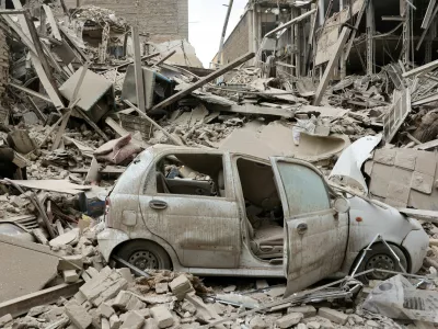 FILE PHOTO: A destroyed vehicle amid rubble at the site of a strike on a residential building, amid the U.S.-Israeli conflict with Iran, in Tehran, Iran, March 16, 2026. Majid Asgaripour/WANA (West Asia News Agency) via REUTERS ATTENTION EDITORS - THIS PICTURE WAS PROVIDED BY A THIRD PARTY/File Photo