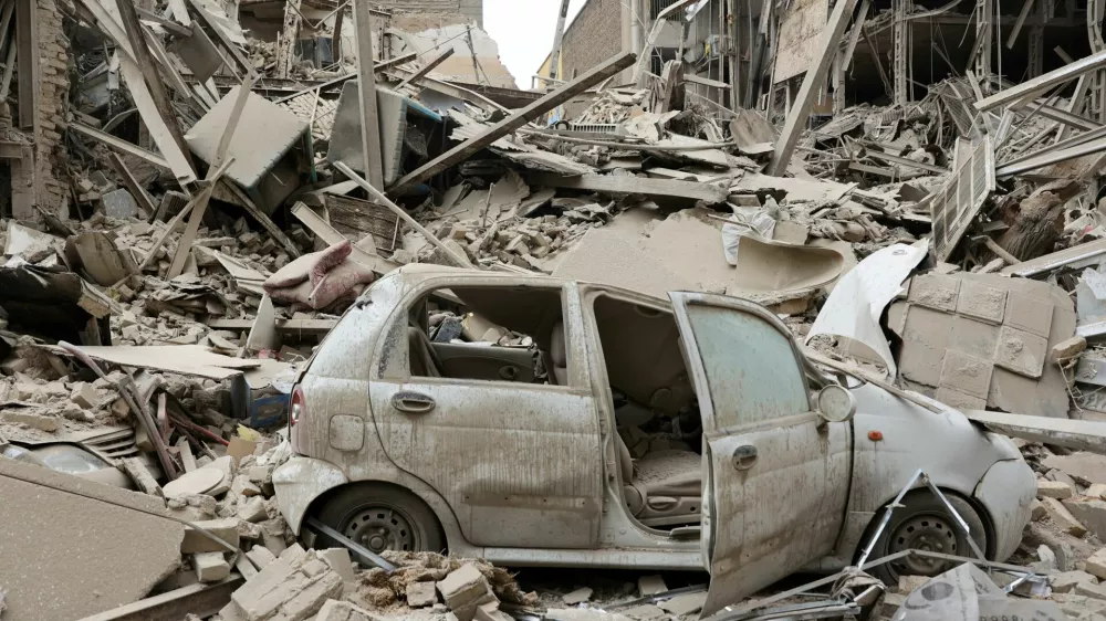 FILE PHOTO: A destroyed vehicle amid rubble at the site of a strike on a residential building, amid the U.S.-Israeli conflict with Iran, in Tehran, Iran, March 16, 2026. Majid Asgaripour/WANA (West Asia News Agency) via REUTERS ATTENTION EDITORS - THIS PICTURE WAS PROVIDED BY A THIRD PARTY/File Photo