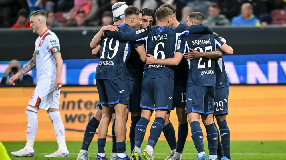 Hoffenheim's Bazoumana Toure celebrates with teammates after scoring during the German Bundesliga soccer match between FC Augsburg and TSG 1899 Hoffenheim in Augsburg, Germany, Friday, April 10, 2026. (Harry Langer/dpa via AP)