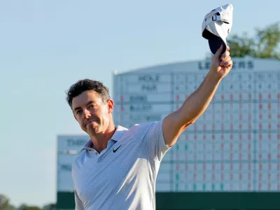 Golf - The Masters - Augusta National Golf Club, Augusta, Georgia, U.S. - April 10, 2026 Northern Ireland's Rory McIlroy celebrates on the 18th hole during the second round as the scoreboard is seen REUTERS/Mike Blake   TPX IMAGES OF THE DAY