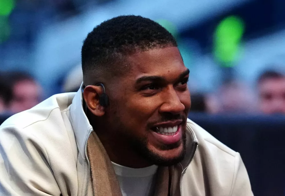 Boxer Anthony Joshua watches the fights in London, Saturday, April 11, 2026. (Bradley Collyer/PA via AP)