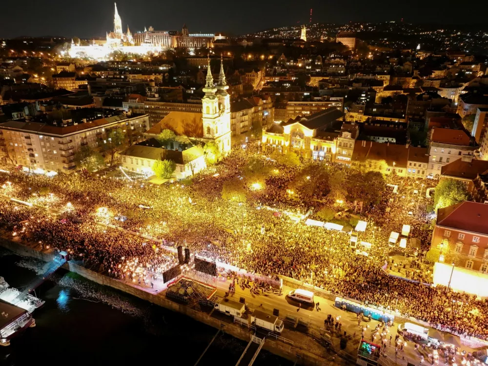 A drone view shows people gathering to celebrate across the River Danube from the Parliament building, following the partial results of the parliamentary election, in Budapest, Hungary, April 12, 2026. REUTERS/Stringer   TPX IMAGES OF THE DAY