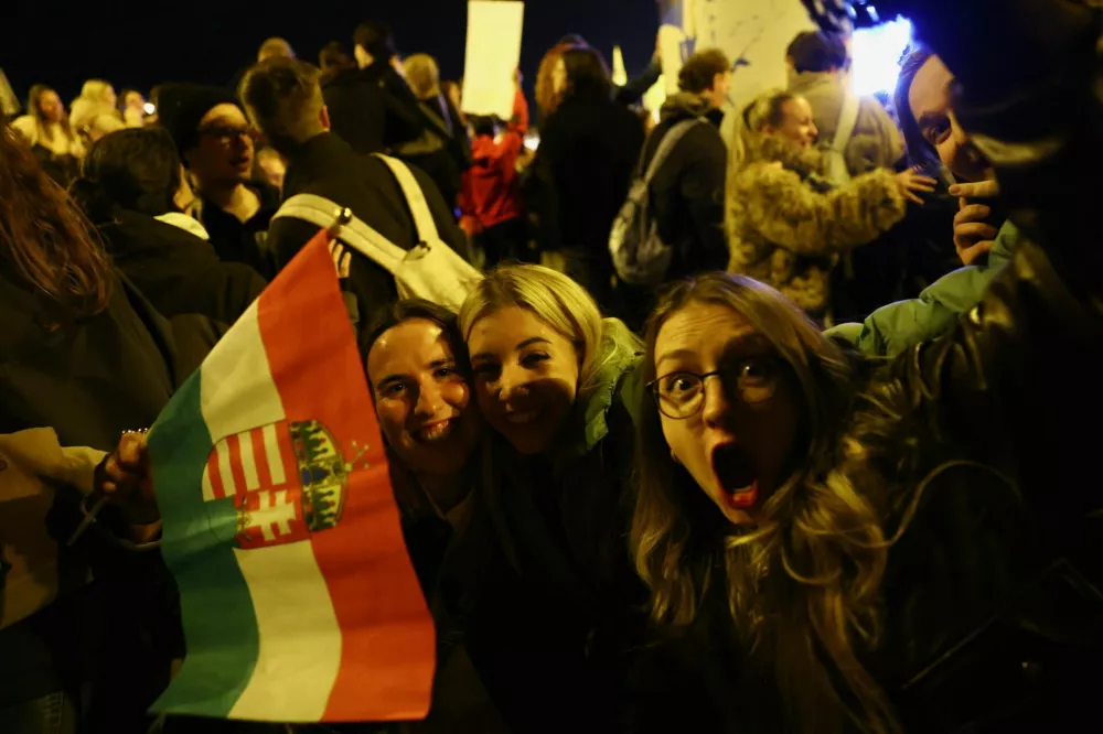 People celebrate following partial results on the day of the Hungarian Parliamentary election in Budapest, Hungary, April 13, 2026. REUTERS/Bernadett Szabo