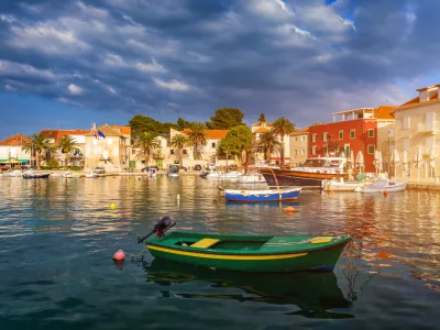 Fishing boat anchoring in beautiful Sutivan port, Brac island, Croatia. Sutivan on Island Brac in Croatia. Made of well known white limestone. Port with fishing boats. Sutivan, Brac, Croatia.