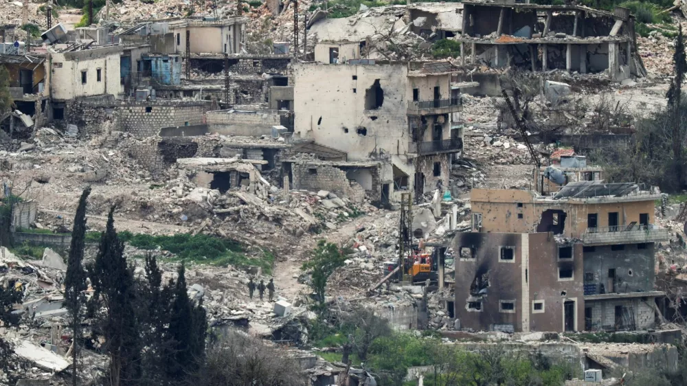 Israeli soldiers stand among destroyed buildings in southern Lebanon, near the Israel-Lebanon border, as seen from the Israeli side of the border in northern Israel, April 14, 2026. REUTERS/Florion Goga REFILE - QUALITY REPEAT