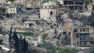 Israeli soldiers stand among destroyed buildings in southern Lebanon, near the Israel-Lebanon border, as seen from the Israeli side of the border in northern Israel, April 14, 2026. REUTERS/Florion Goga REFILE - QUALITY REPEAT