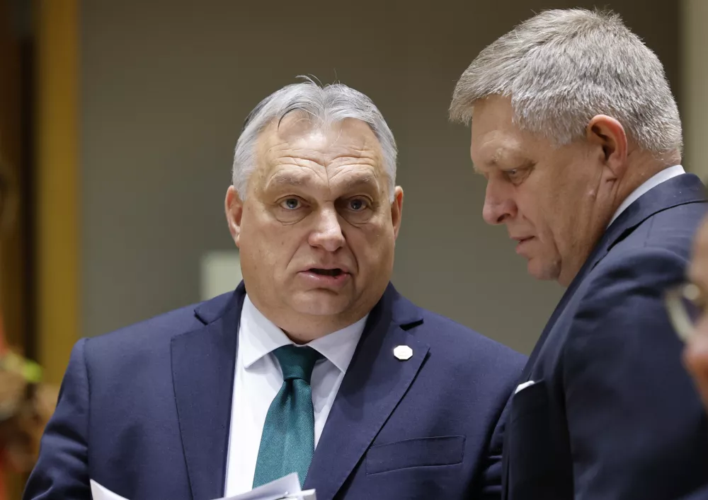 Slovakia's Prime Minister Robert Fico, right, talks to Hungary's Prime Minister Viktor Orban during a round table meeting at an EU summit in Brussels, Thursday, Feb. 1, 2024. European Union leaders meet in Brussels for a one day summit to discuss the revision of the Multiannual Financial Framework 2021-2027, including support for Ukraine. (AP Photo/Geert Vanden Wijngaert)