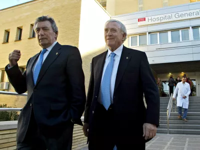 FILE -Former Real Madrid soccer players Enrique Perez "Pachin", left, and Jose Emilio Santamaria leave La Fe hospital in Valencia, Spain, Dec. 27, 2005 after visiting their former teammate Alfredo di Stefano, of Argentina. (AP Photo/Fernando Bustamante, File)