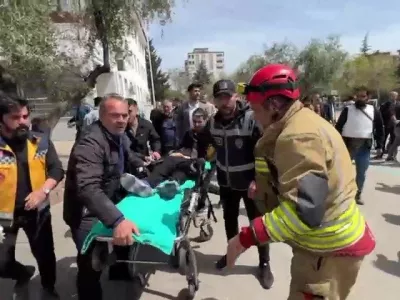 An injured person is carried to an ambulance following a school shooting, in the southeastern province of Kahramanmaras, Turkey, April 15, 2026. IHA (Ihlas News Agency) via REUTERS ATTENTION EDITORS - THIS PICTURE WAS PROVIDED BY A THIRD PARTY