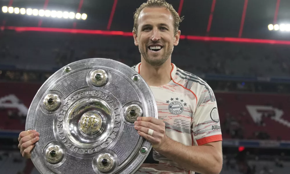 Bayern's Harry Kane poses with the championship shield after the German Bundesliga soccer match between FC Bayern Munich and Borussia Moenchengladbach in Munich, Germany, Saturday, May 10, 2025. (AP Photo/Matthias Schrader)