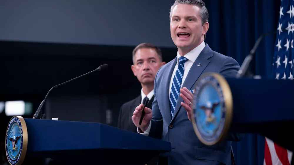Defense Secretary Pete Hegseth speaks to members of the media during a press briefing at the Pentagon, Thursday, April 16, 2026 in Washington. Behind Hegseth is Adm. Brad Cooper. (AP Photo/Kevin Wolf)