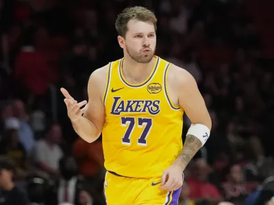 Los Angeles Lakers guard Luka Doncic (77) reacts after scoring during the second half of an NBA basketball game against the Miami Heat, Thursday, March 19, 2026, in Miami. (AP Photo/Lynne Sladky)