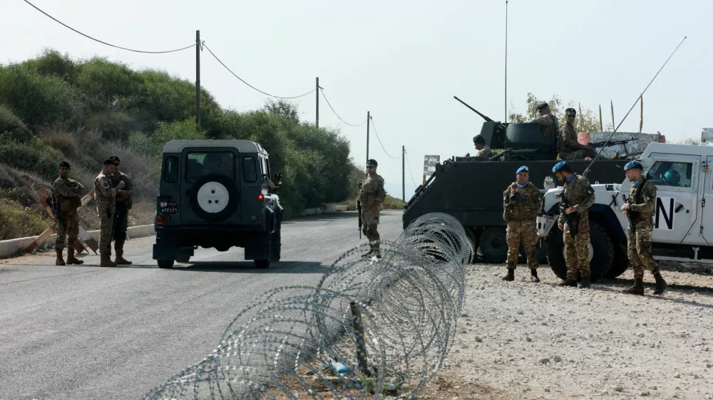 FILE PHOTO: United Nations peacekeepers (UNIFIL) and Lebanese army soldiers stand guard at a checkpoint in Naqoura, near the Lebanese-Israeli border, southern Lebanon, October 27, 2022. REUTERS/Aziz Taher/File Photo