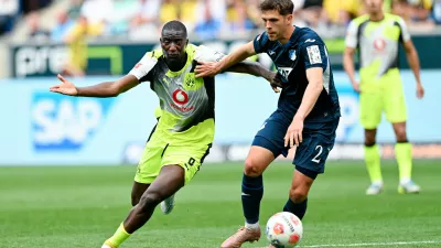 Dortmund's Serhou Guirassy, left, and Hoffenheim's Robin Hranac battle for the ball during their German Bundesliga soccer match in Sinsheim, Germany, Saturday, April 18, 2026. (Uwe Anspach/dpa via AP)
