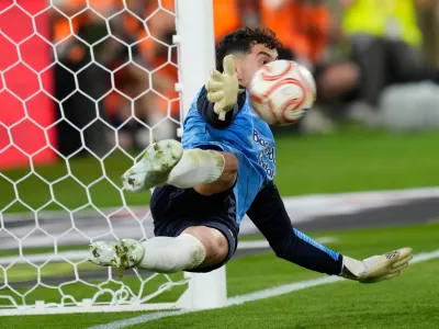 Real Sociedad's goalkeeper Unai Marrero makes a save during during the penalty shoot out at the Copa del Rey final soccer match between Atletico Madrid and Real Sociedad in Seville, Spain, Saturday, April. 18, 2026. (AP Photo/Jose Breton)