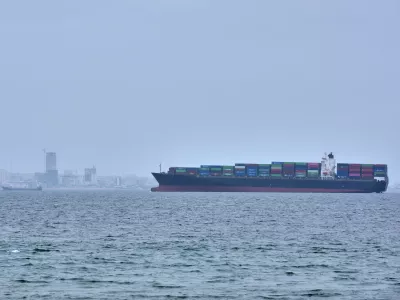 A container ship is seen in the Strait of Hormuz off the coast of Qeshm Island, Iran, Saturday, April 18, 2026. (AP Photo/Asghar Besharati)