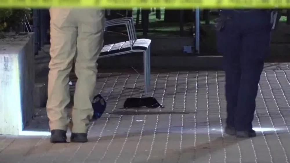 This image made from video provided by KCRG shows Iowa City police officers working the scene of a downtown shooting near the University of Iowa campus on Sunday, April 19, 2026. (KCRG via AP)